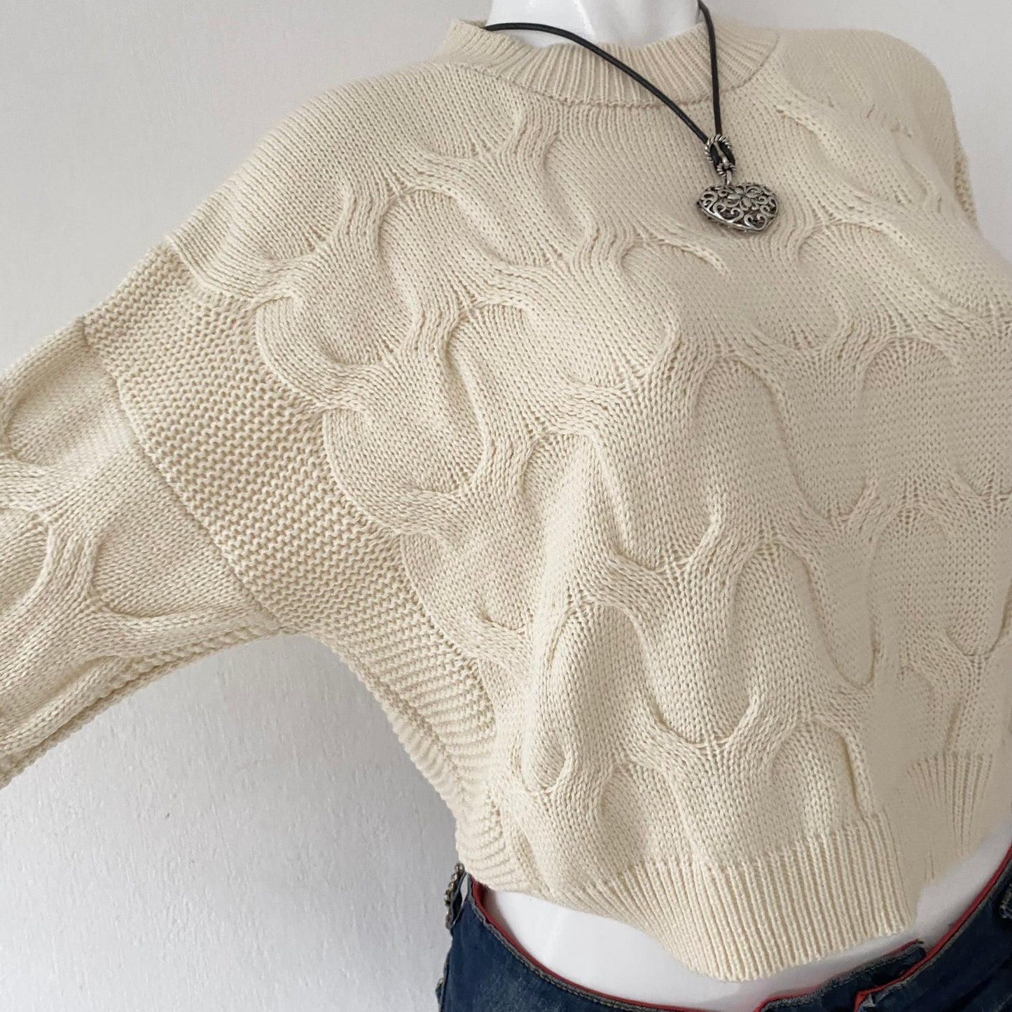 Pearl waist sweater with interwoven design
