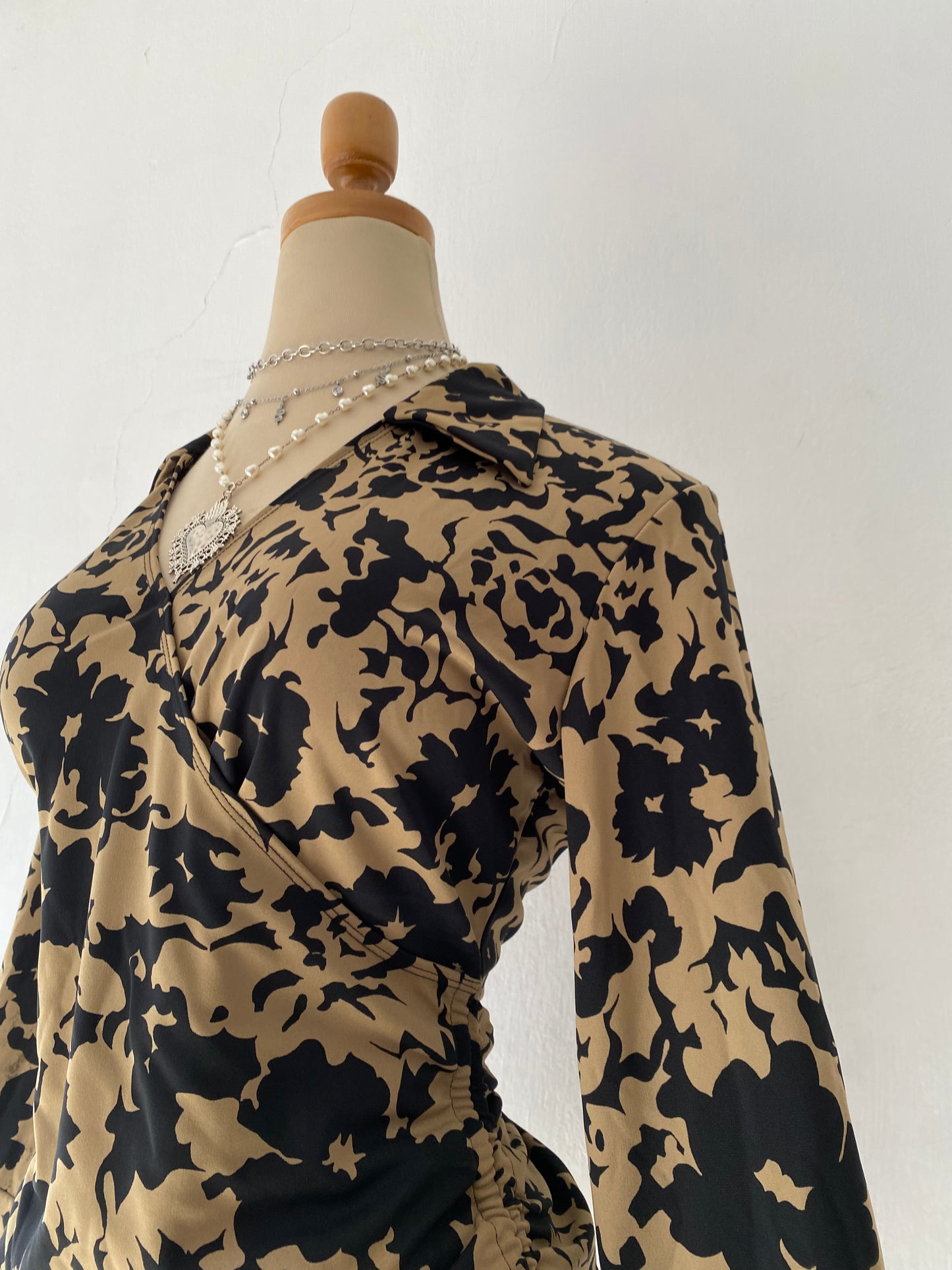 Beige and black crossover blouse