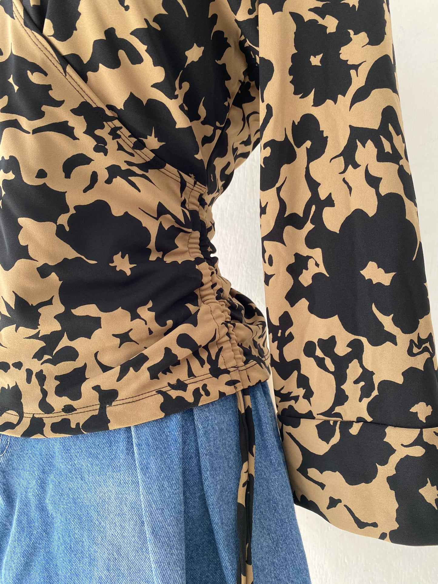 Beige and black crossover blouse