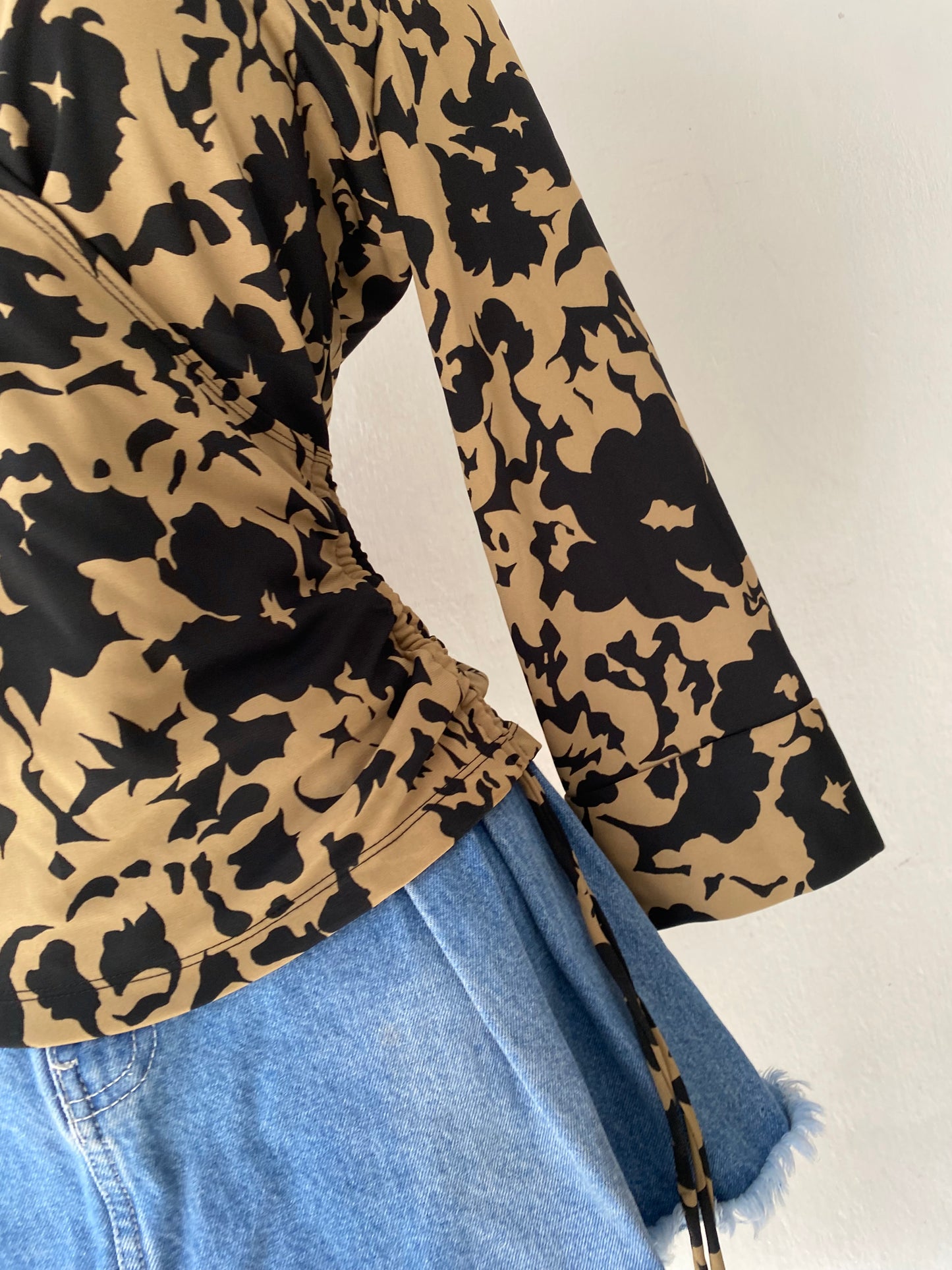 Beige and black crossover blouse