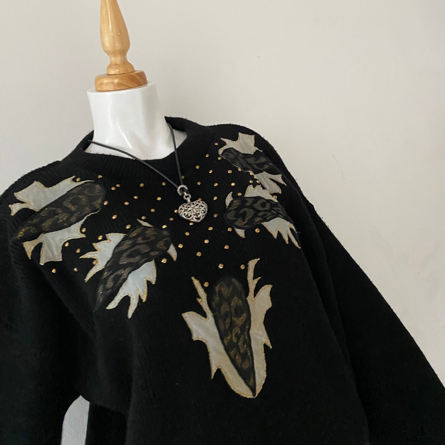 black sweater with animal print appliqués