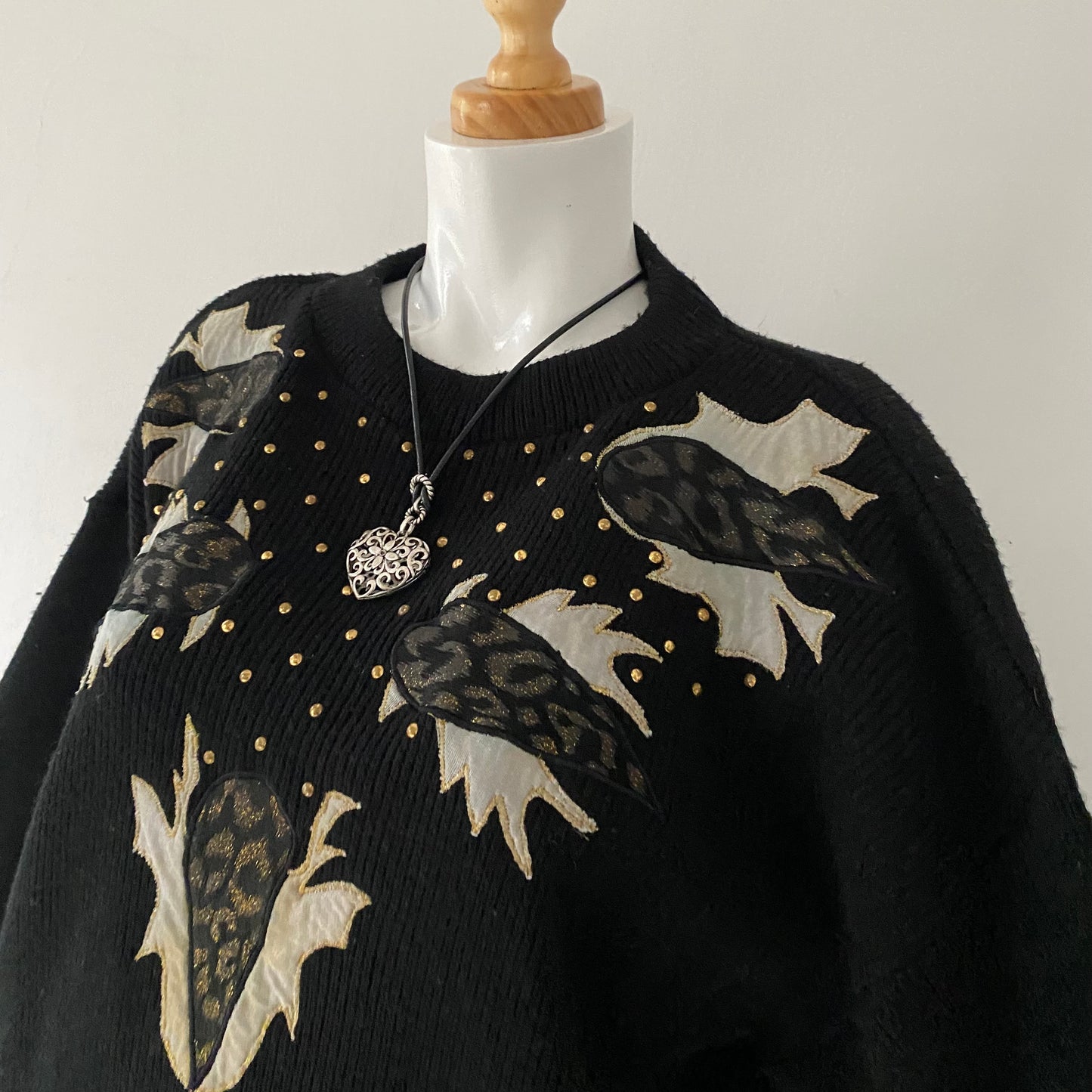 black sweater with animal print appliqués