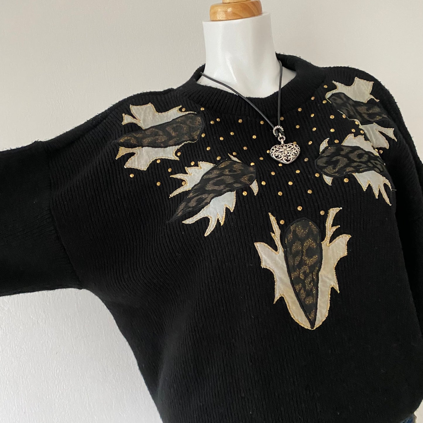 black sweater with animal print appliqués