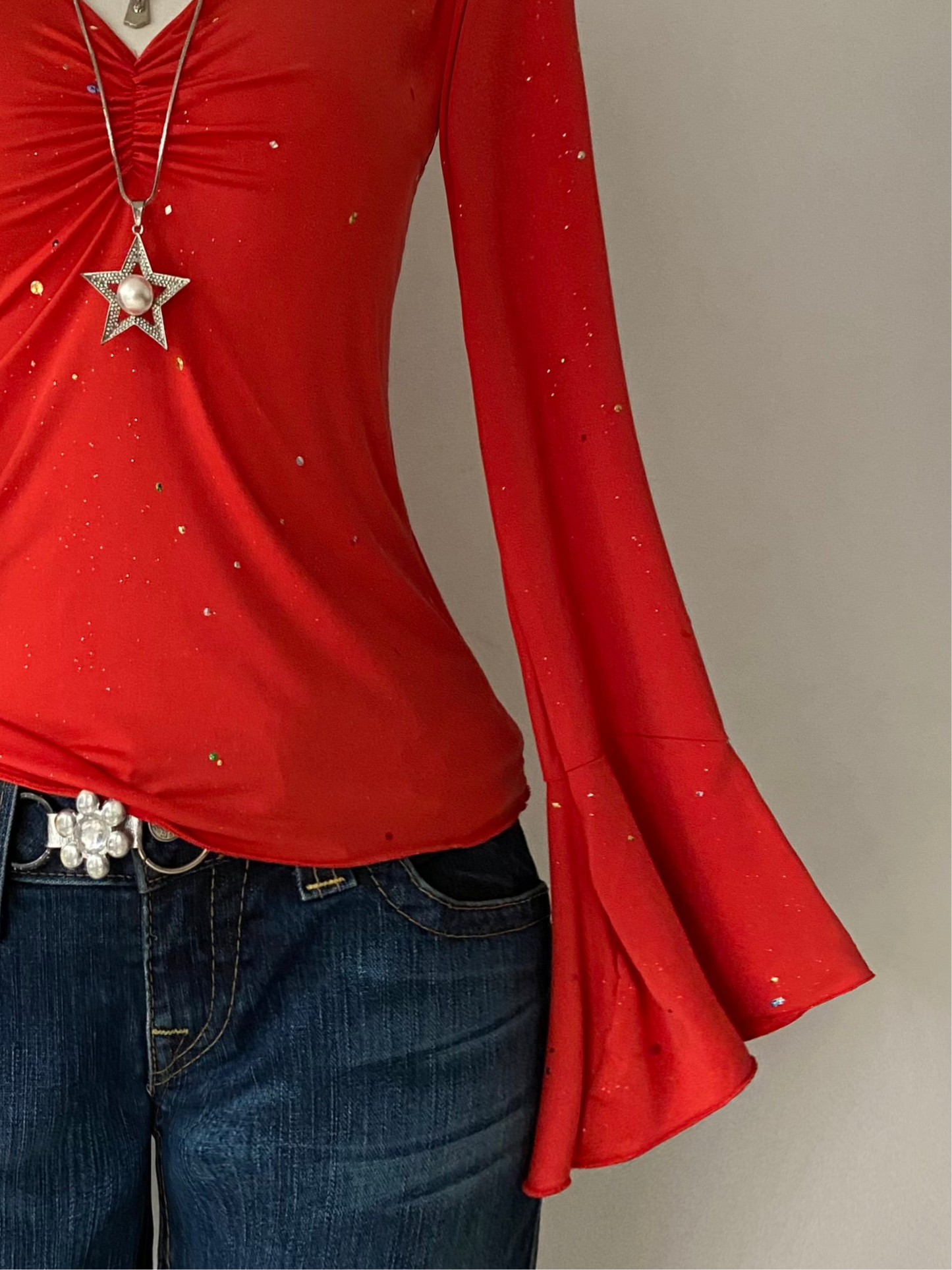 Bell-sleeved top with appliqués