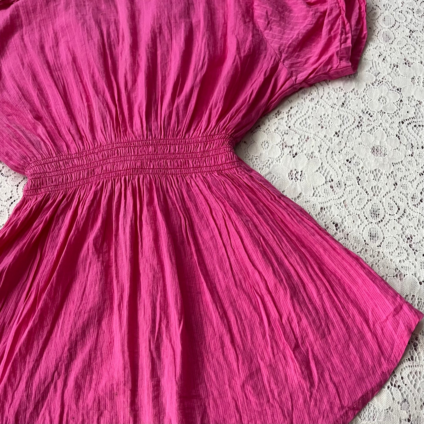 Pink blouse with a bow at the waist