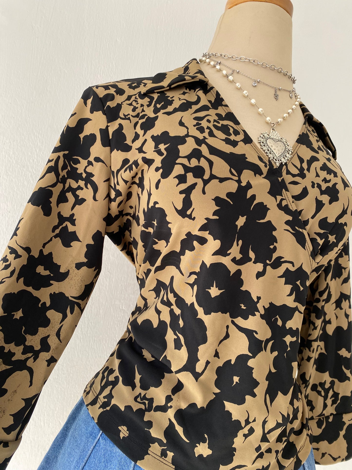 Beige and black crossover blouse