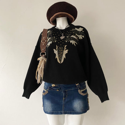 black sweater with animal print appliqués