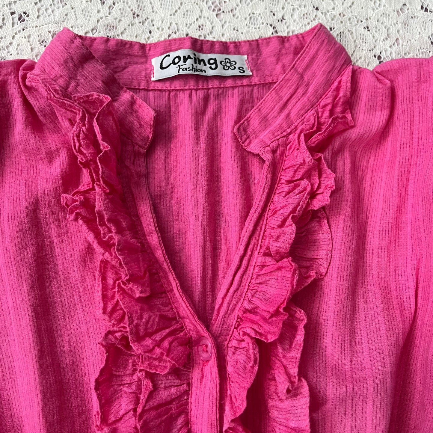 Pink blouse with a bow at the waist