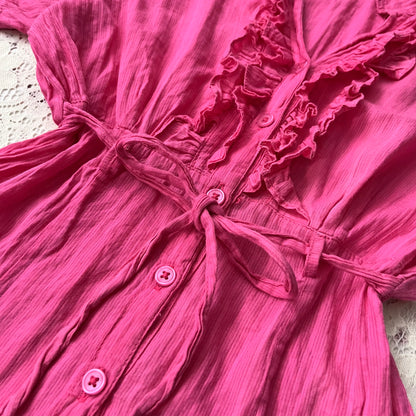 Pink blouse with a bow at the waist