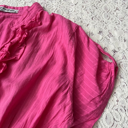 Pink blouse with a bow at the waist