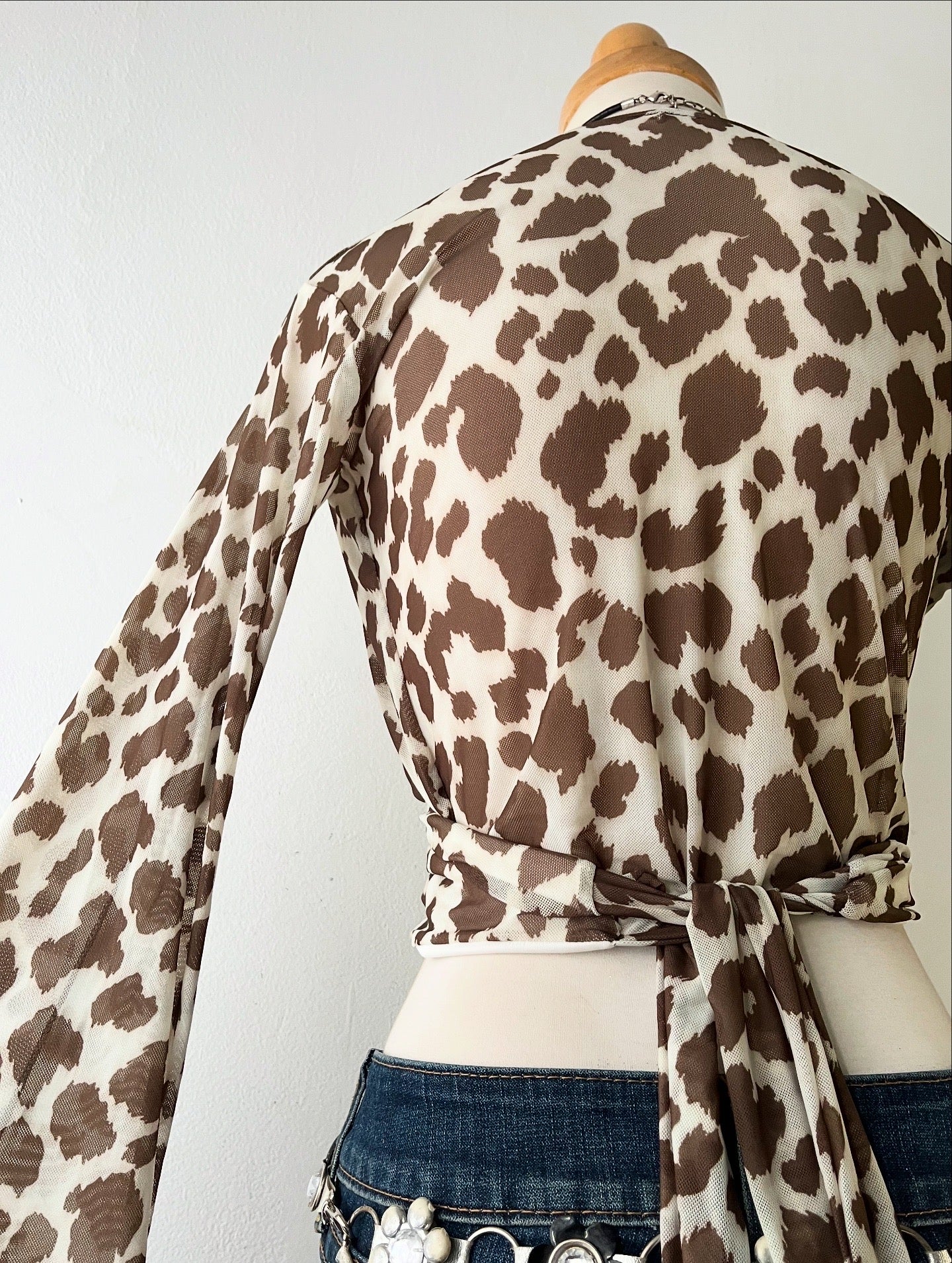 Wraparound animal print top with flared sleeves