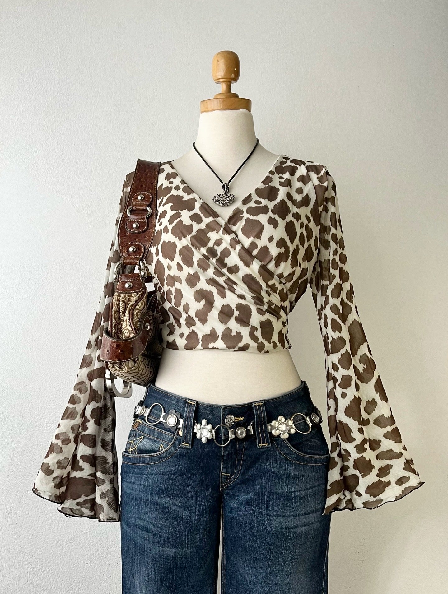 Wraparound animal print top with flared sleeves