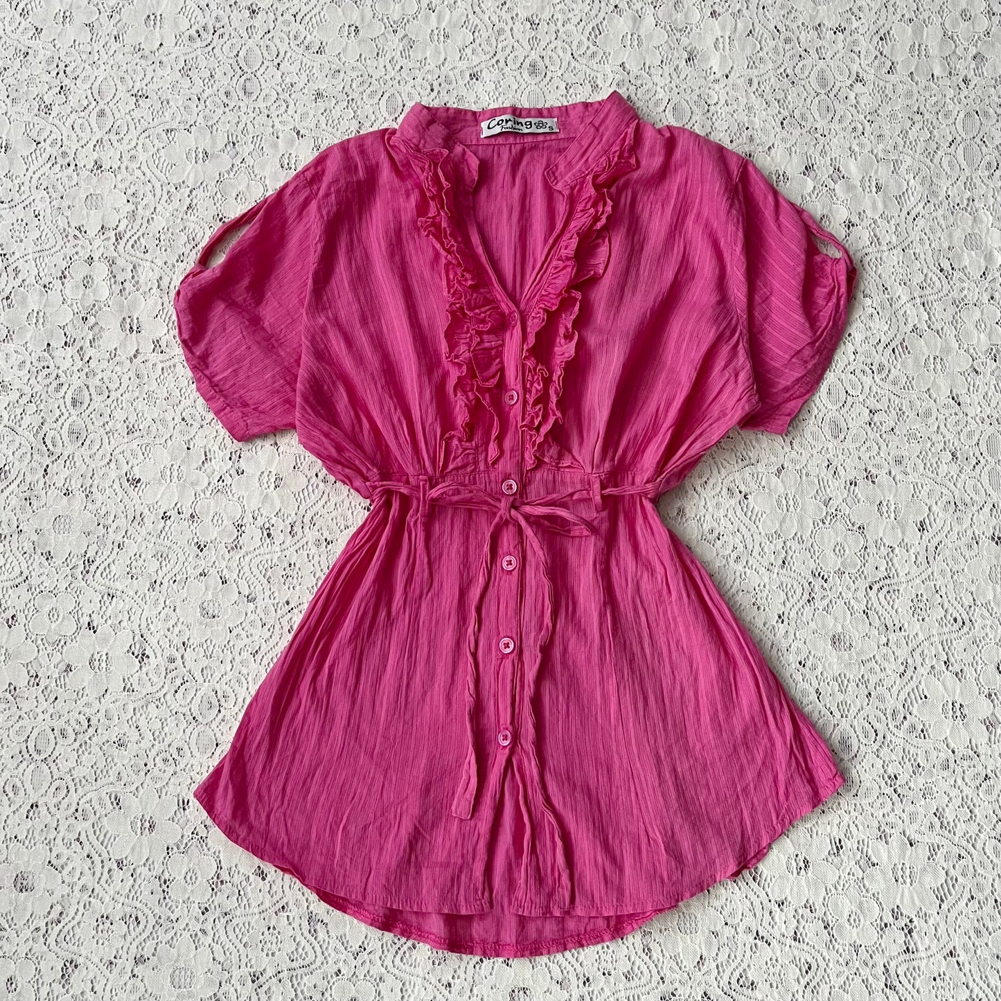 Pink blouse with a bow at the waist